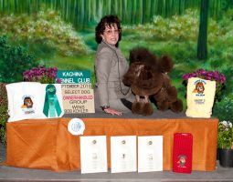 A woman poses with a poodle and awards after winning at the Kachina Kennel Club dog show in September 2018.